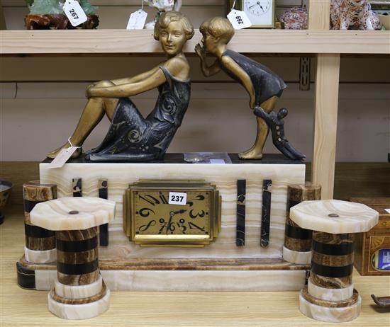 A French Art Deco marble and alabaster clock garniture with figural surmount width 58cm height 51cm